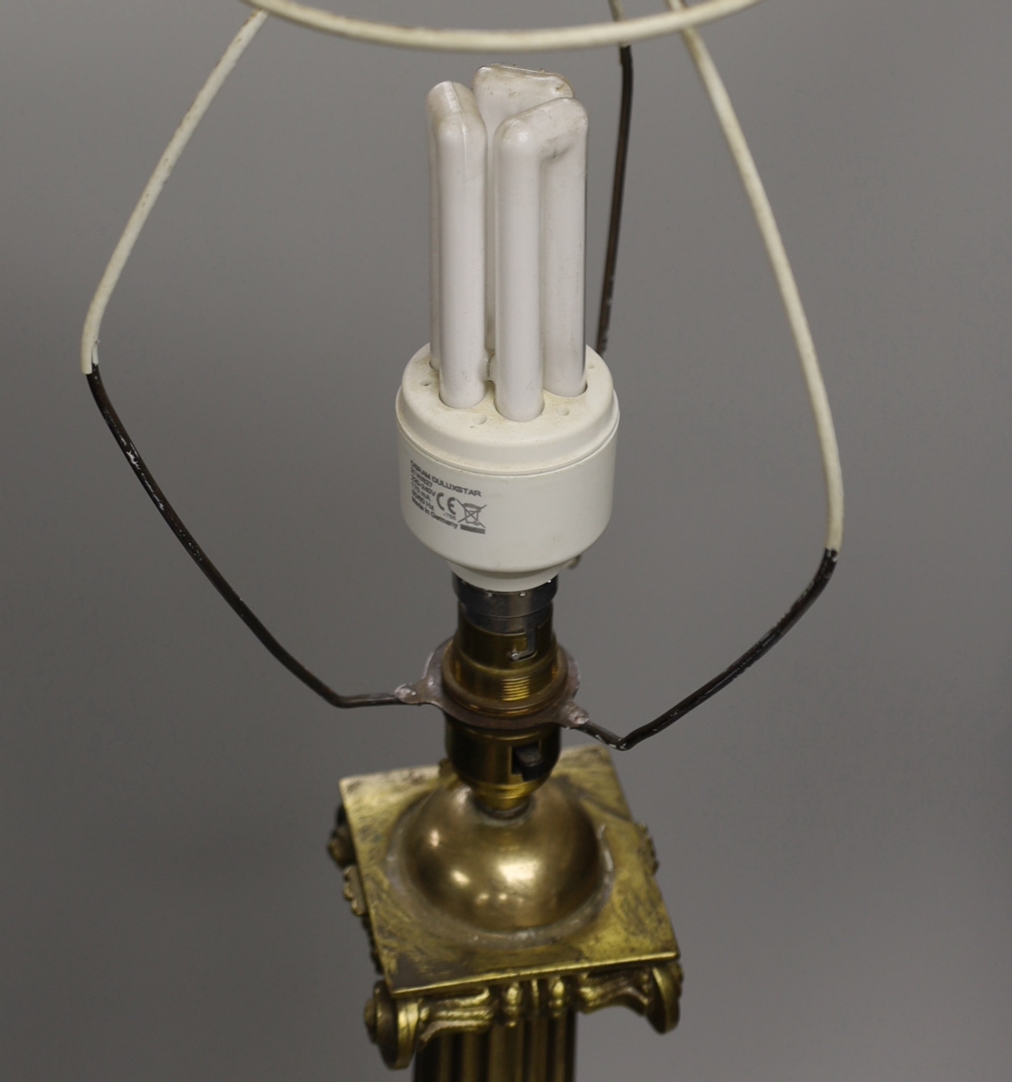 A large brass desk lamp in the form of a tapering column, on plinth base, 56cm to top of column